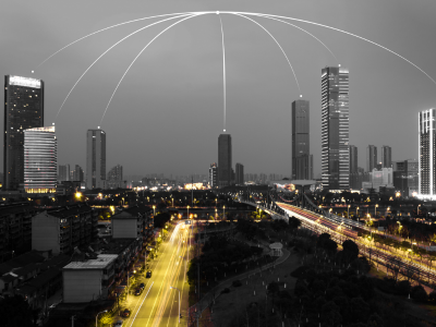 A modern Smart City skyline featuring connected digital infrastructure.